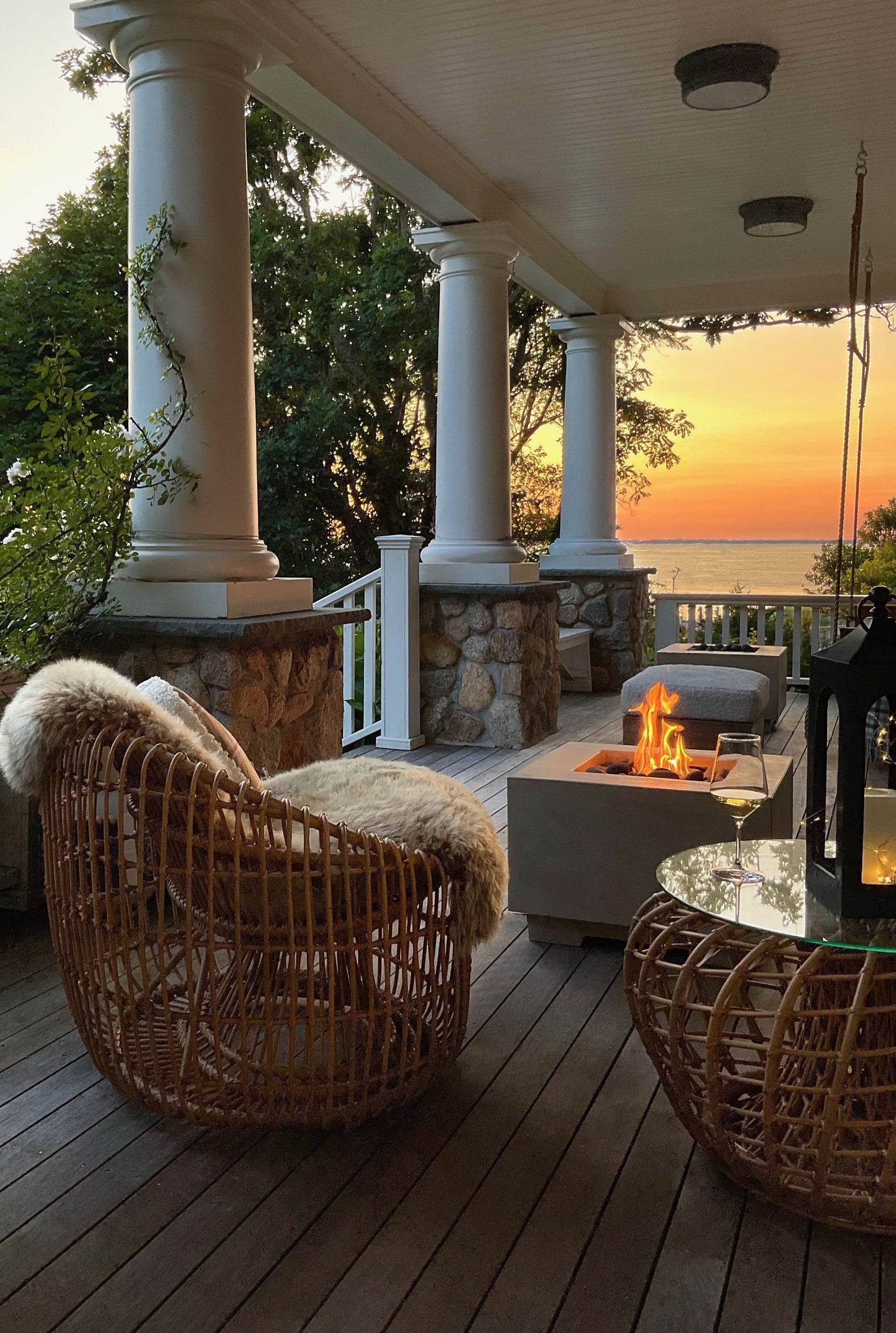 Cozy veranda with sunset view on Cape Cod furnished with Cane-line Nest round chair and Nest coffee table with a natural coloured rattan look a like material