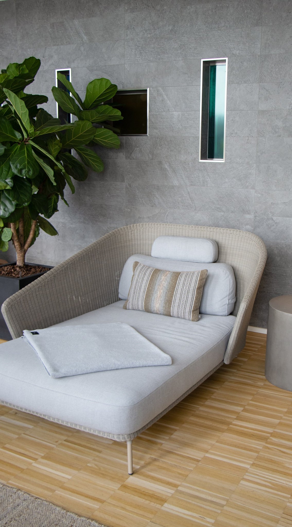 Relax area at Alsik Spa with white Mega daybed from Cane-line, green plant on the left side