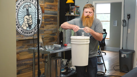 carrying bucket of wort to a fermentation chamber