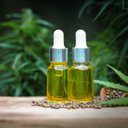 cbd oil on a table surrounded by pebbles