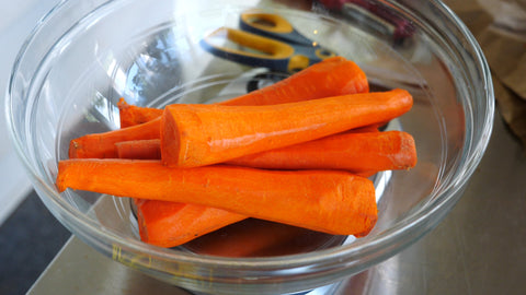 a bowl of peeled carrots