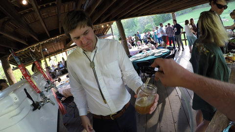 ross pouring the tripel at a wedding