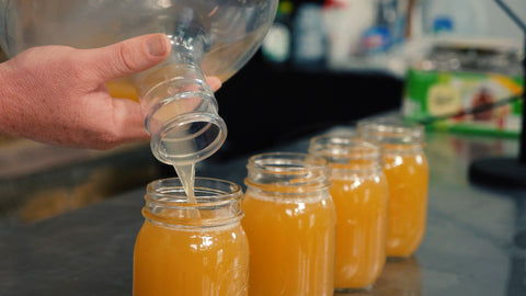 pouring harvested yeast into mason jars for storage
