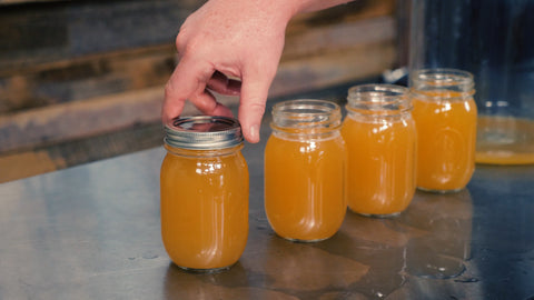 putting a lid on a mason jar filled with harvested yeast