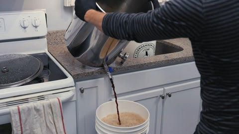 transferring wort to a fermentation bucket using the ball valve at the bottom of the kettle