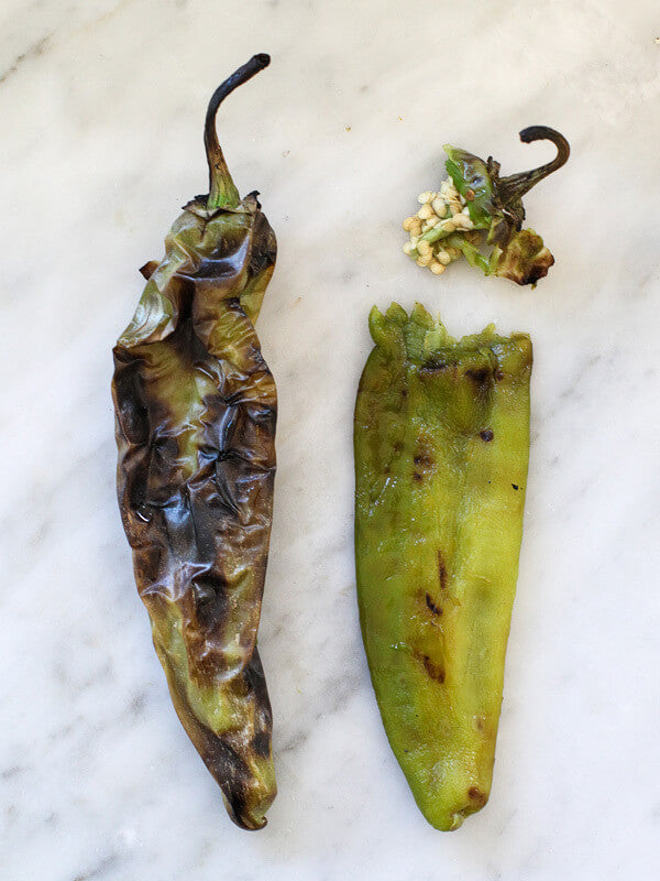 2 roasted jalapeño, one has a separated stem