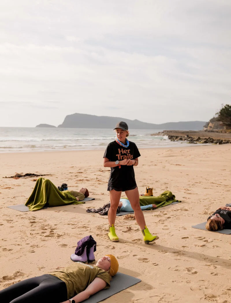 Samantha coaching people on the sand