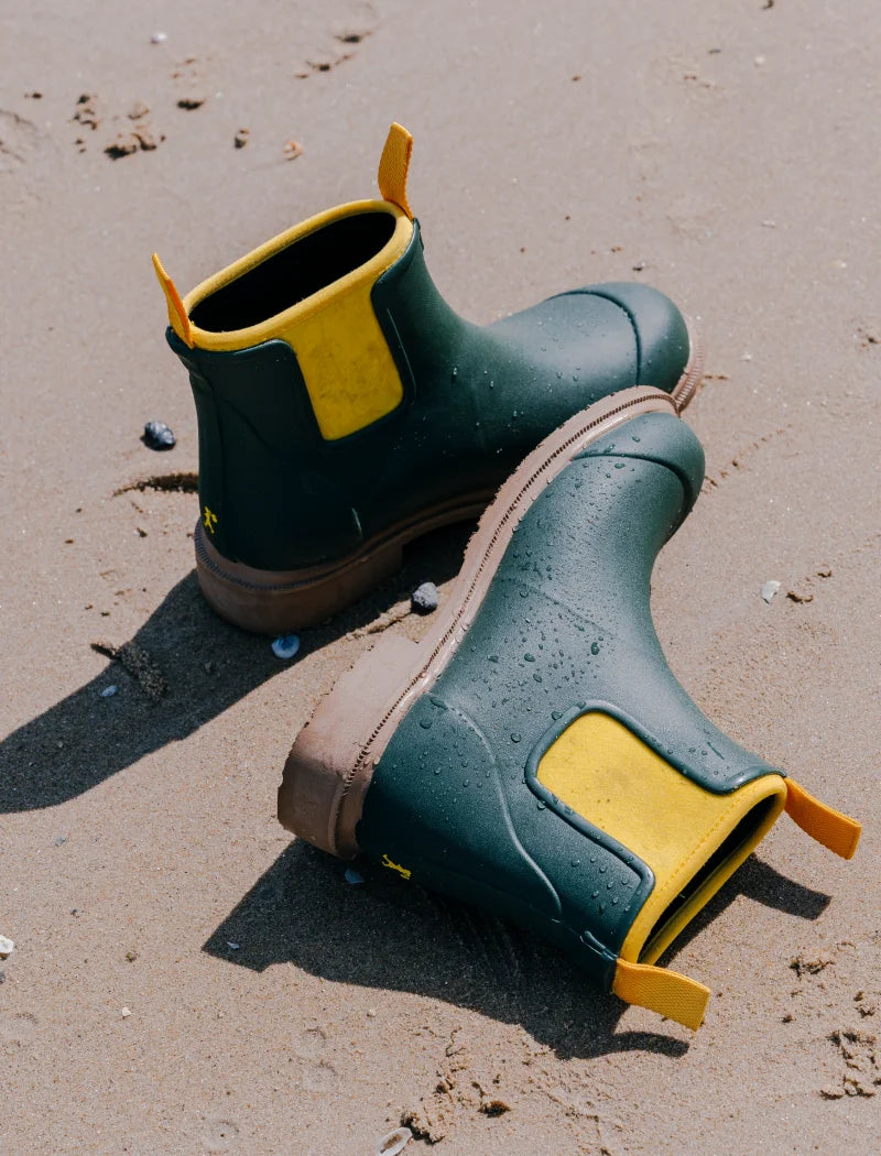 green boots on the beach sand