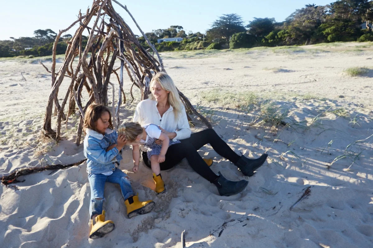 mother and her daughters on the beach