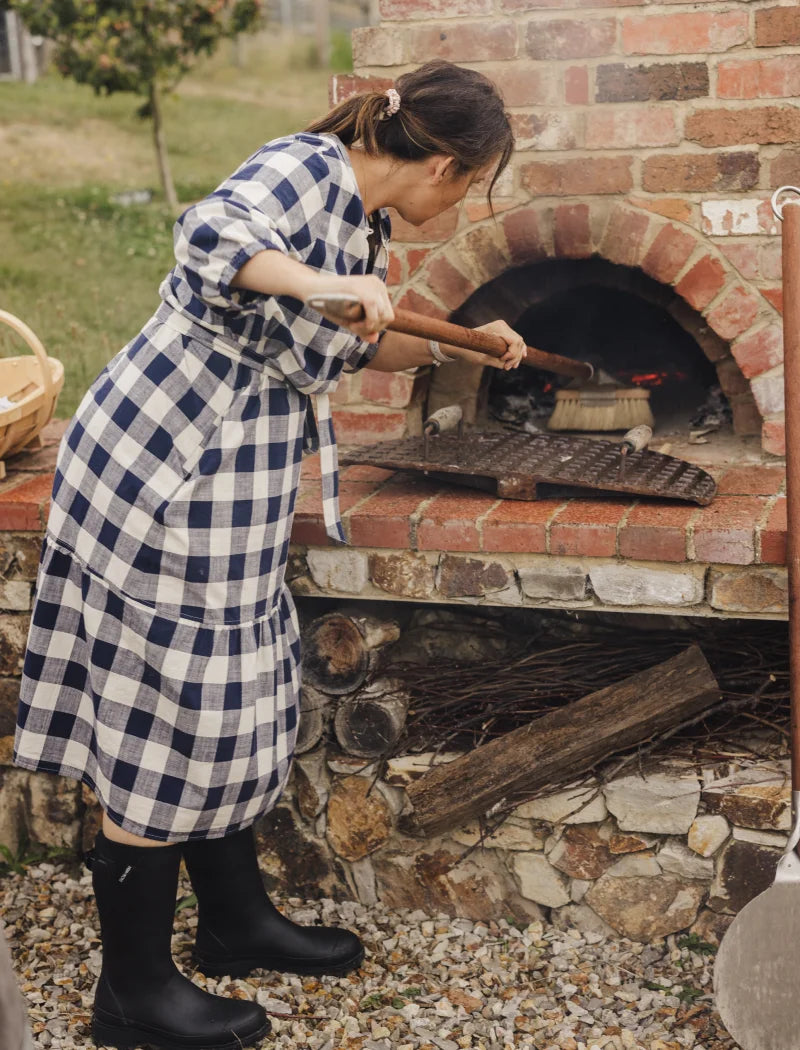 moving the pizza in the pizza oven