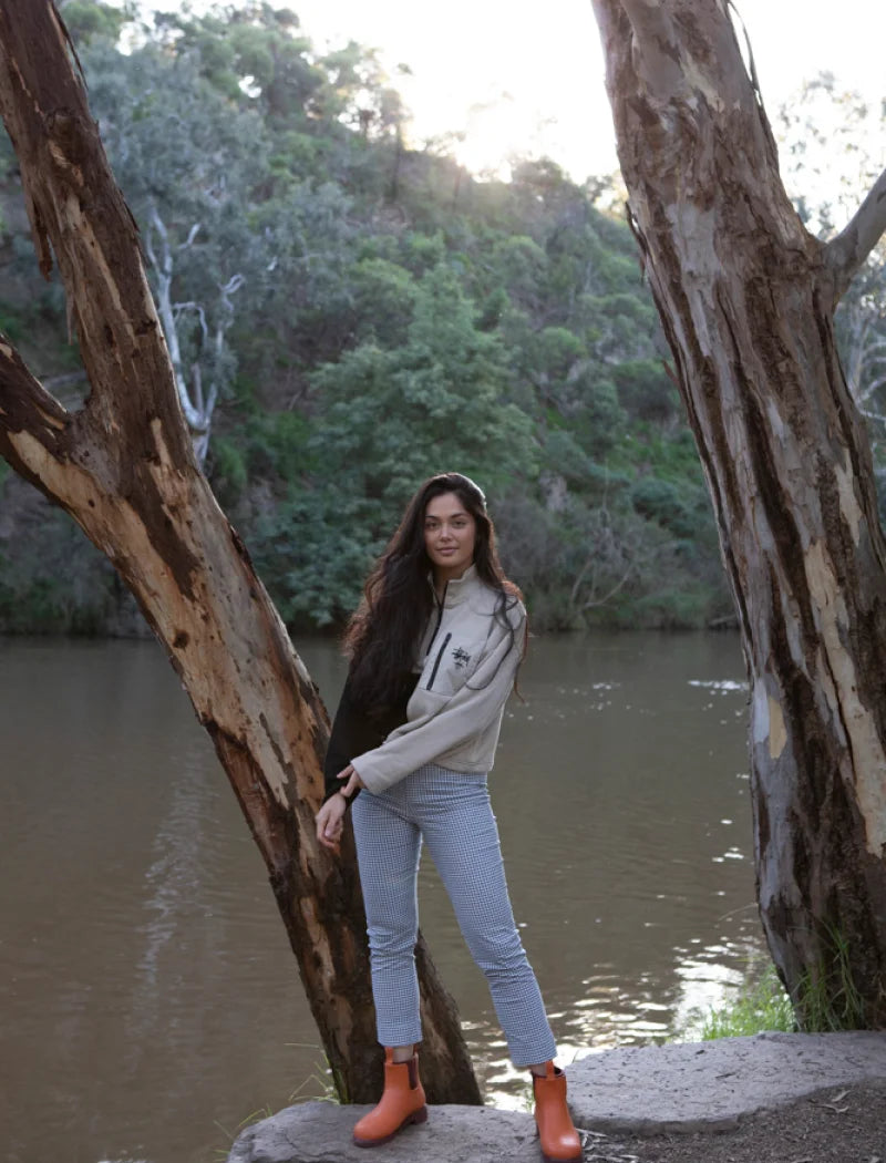 orange boots beside the river