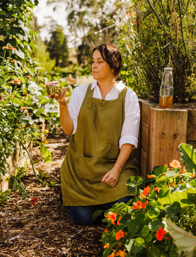 photo in the garden holding a jar