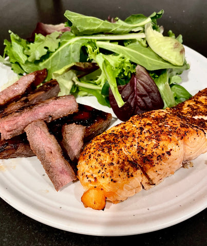 Steak, salmon and salad meal