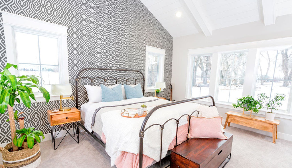 A light and airy bedroom with a patterned accent wall