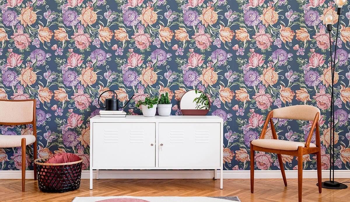 Bold floral wallpaper, two chairs, and a white cabinet