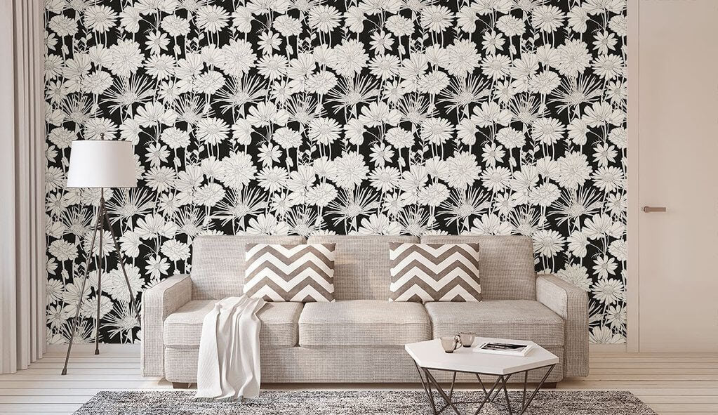 A living room with a near-monochrome look with a floral wallpaper accent wall