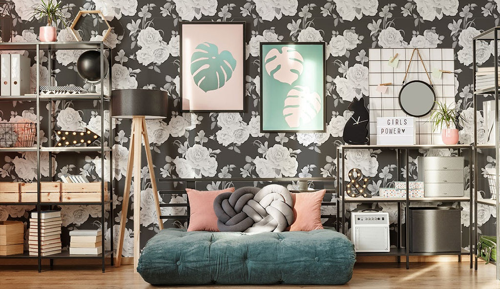 Black and white wallpaper and busy decor in a bedroom