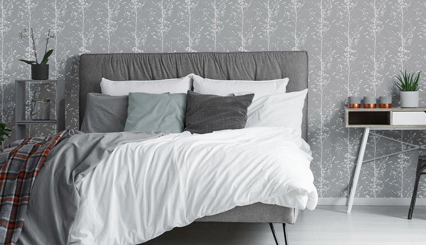 A bedroom with muted gray decor.