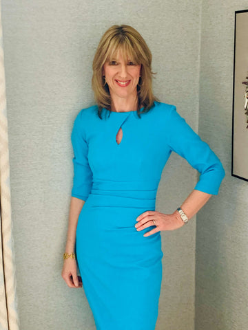 Jules Standish wears a blue Diva Catwalk pencil dress