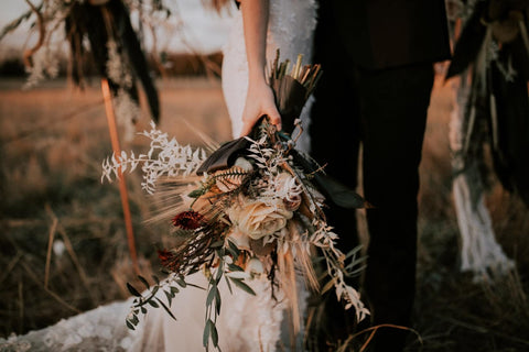 Bride and groom with fall coloured flowers