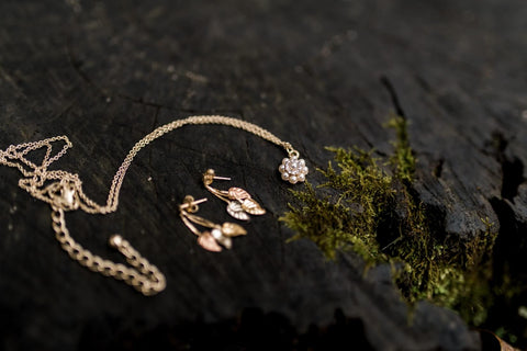 photograph of gold jewellery on a dark wood background 