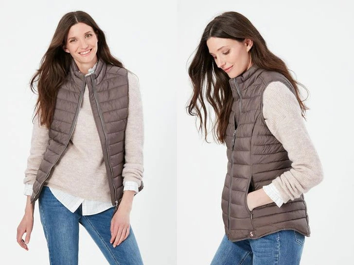  A woman smiling, modelling the Joules Gilet from Next.