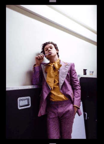Harry Styles in 1970s inspired suit brushing teeth 