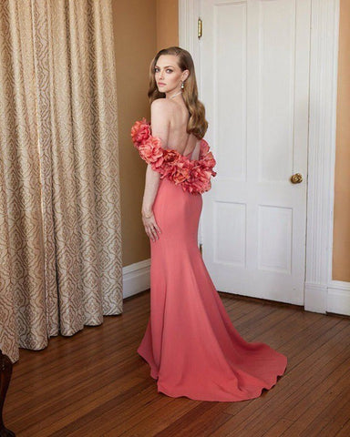 amanda seyfried pictured at the golden globe wearing a long coral gown.