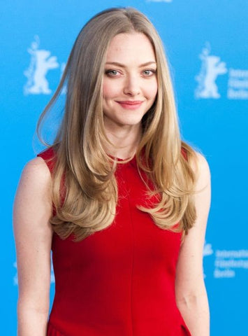 amanda seyfried pictured wearing a dark red sleeveless dress at a premiere.