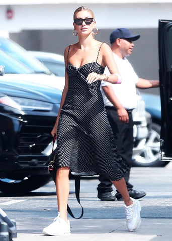 hailey bieber pictured wearing dress and trainers