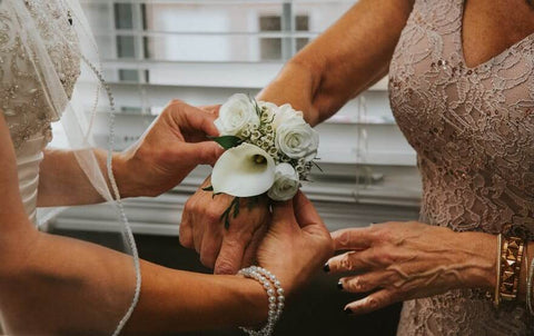 bride and mother with flowers in wist 