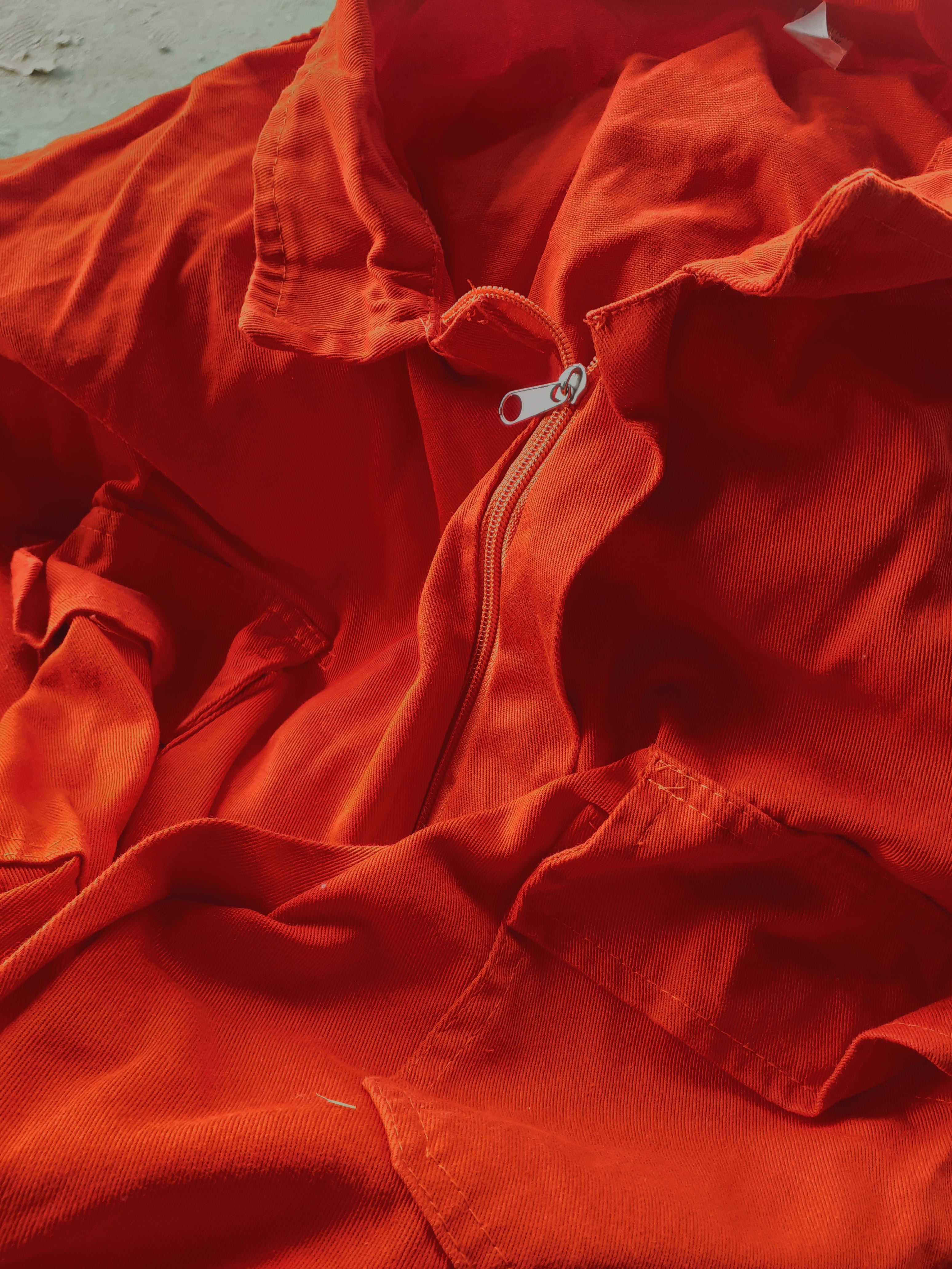 a close up of a red suit zip.