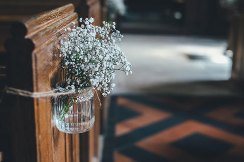 flowers by aisle in a church 