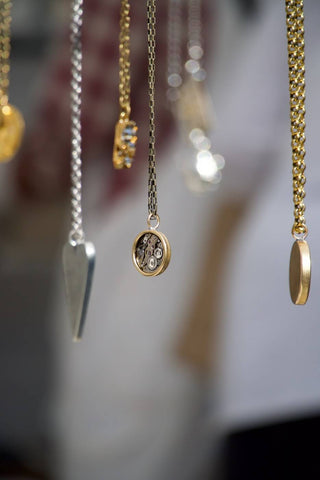 necklaces hanging on a mirror 