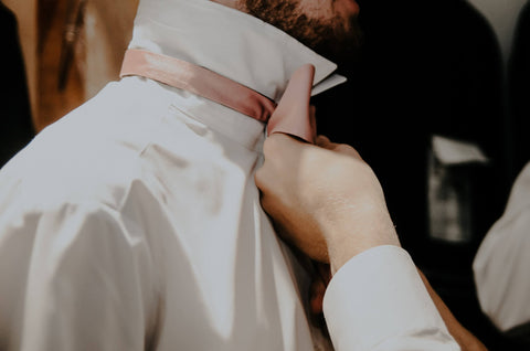 groom in white shirt with pink tie 