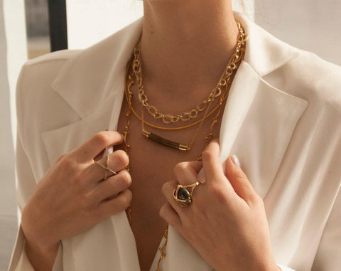 woman wearing suit with lots of jewellery 