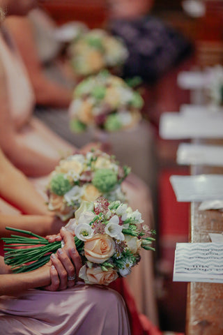 bridesmaids sitting with flowers 