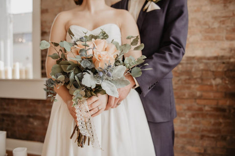 bride and groom with yellow flowers 