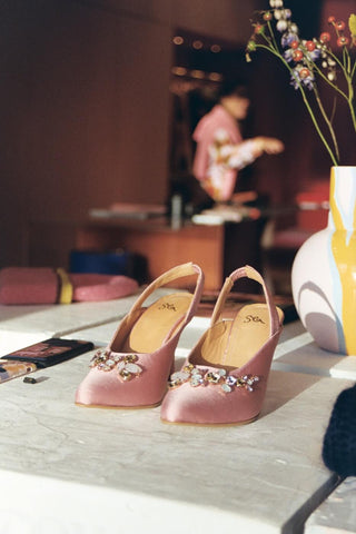 blush pink sandals on a table