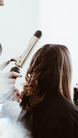 woman having her hair curled 