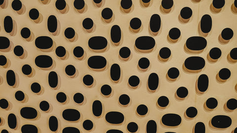 brown background with black polka dots 