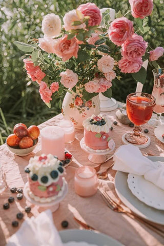 table laid with cakes and flowers 