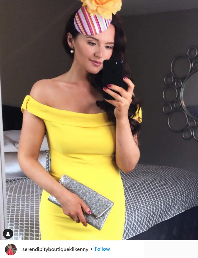 a woman pictured wearing Diva Catwalk's Cloud Off Shoulder Pencil Dress in Blazing Yellow.