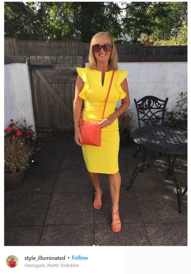 a woman pictured wear Diva Catwalk's Bodiam Pencil Dress in bright yellow.