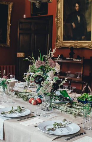 wedding table, with flowers and painting in the background 