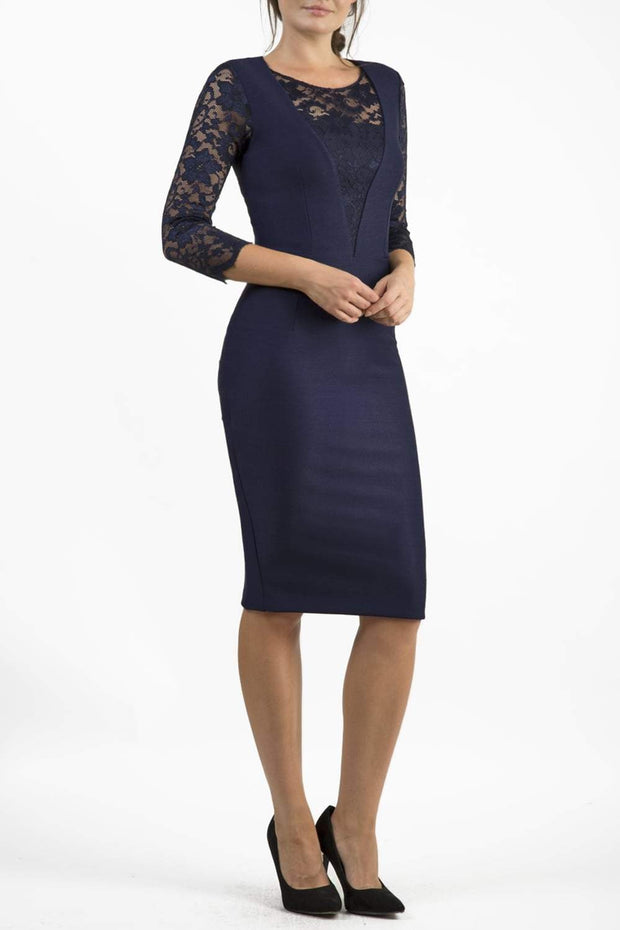 Brunetter Model is wearing seed couture lace pencil dress by diva catwalk in navy front