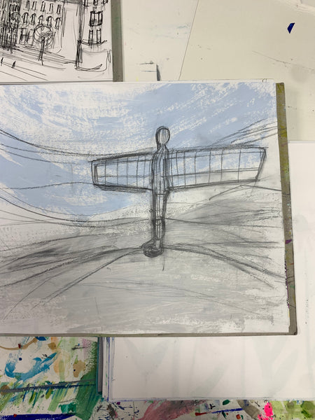 A sketchbook page with a pencil drawing of the Angel of the North drawn on a white page. . 