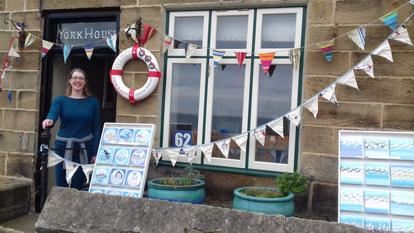 Artist Joanne wishart stands int he doorway of York House in Staithes at the Festival of Art's and Heritage.