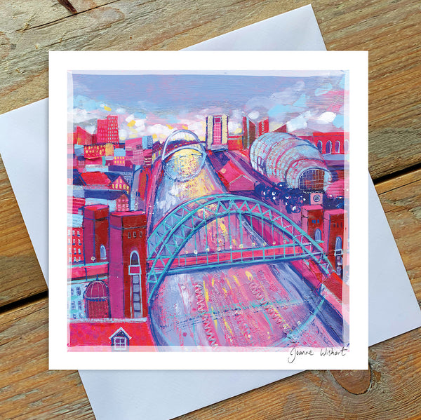 A greetings card featring the curvy shaope of the tyne bridge with the river flowing into the distance towards the baltic. THe scene is cold and pink in colour.  