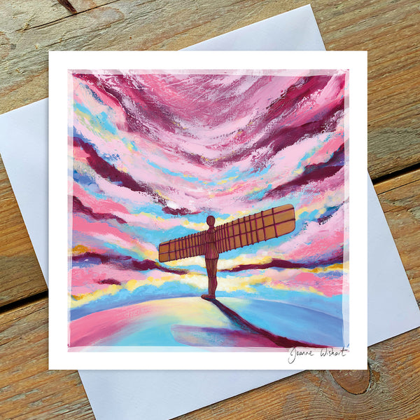 A greetings card featuring the sculpture of the Angel of the North in a dramatic pink cloudy sky. 
